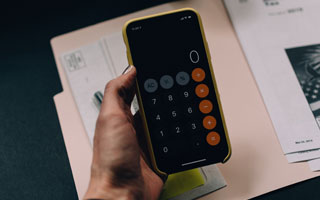 cellphone with calculator app displayed on screen