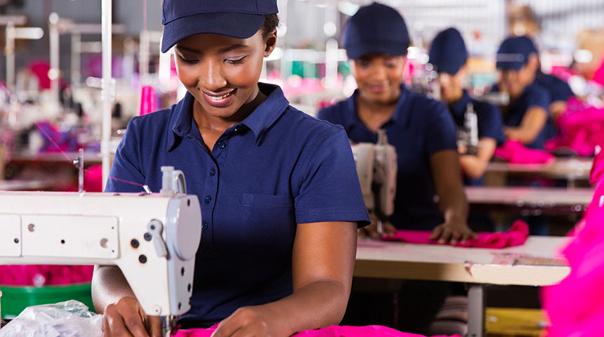 Textile workers sewing on production line