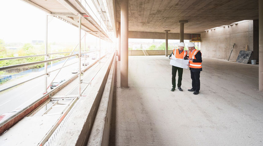 man surveying a newly constructed building